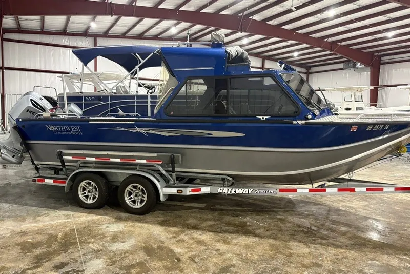 The Image of 2013 Northwest Boats 228 Lightning Outboard on trailer in indoor storage facility. - 0