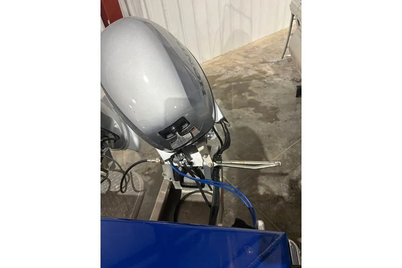 Slide: The Image of 2013 Northwest Boats 228 Lightning Outboard engine in a garage setting. - 16
