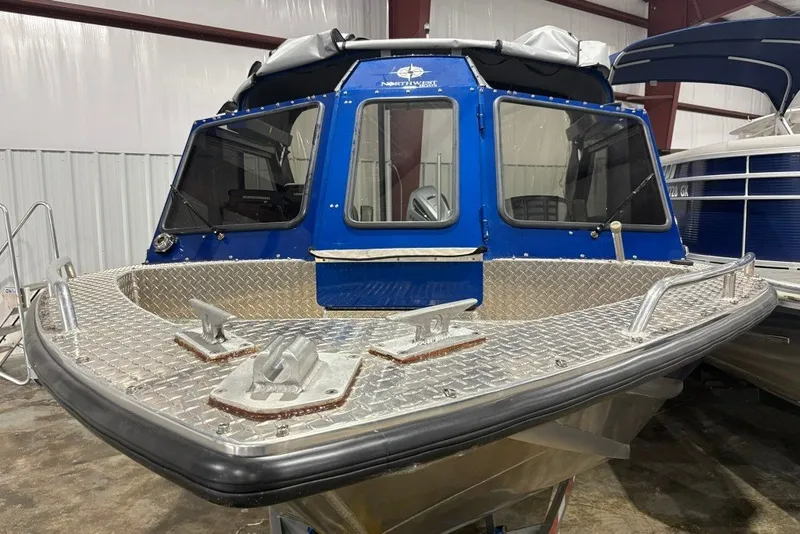 Slide: The Image of 2013 Northwest Boats 228 Lightning Outboard, blue cabin, aluminum deck, indoor display. - 5