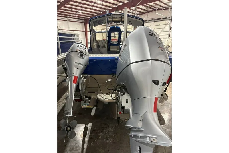 Slide: The Image of 2013 Northwest Boats 228 Lightning Outboard with dual engines in a storage facility. - 7