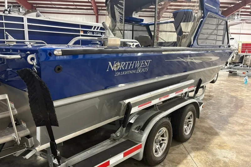 Slide: The Image of 2013 Northwest Boats 228 Lightning Outboard on trailer in indoor storage facility. - 3