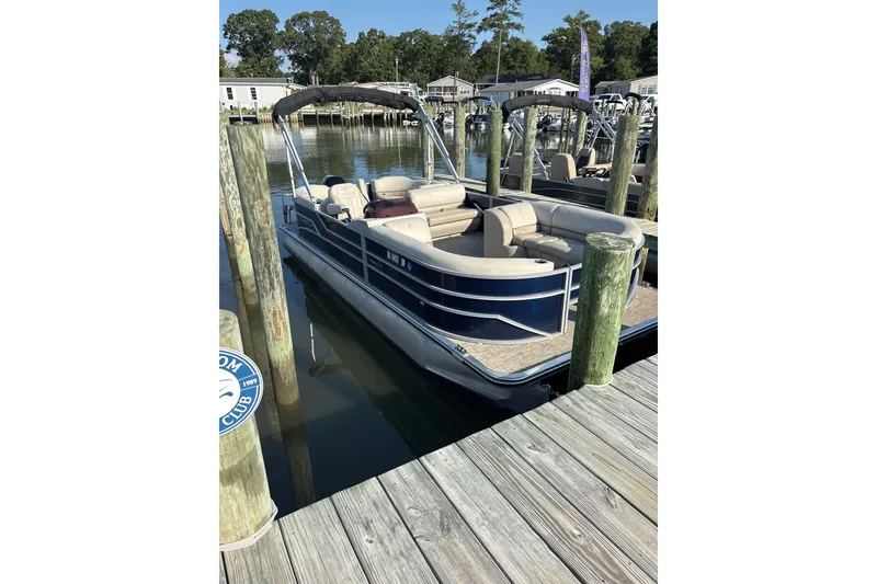 Slide: The Image of 2023 Cypress Cay Seabreeze 232 pontoon boat docked at marina. - 1