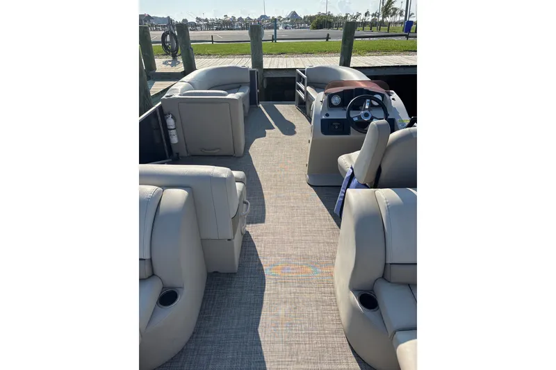 Slide: The Image of 2023 Cypress Cay Seabreeze 232 pontoon boat interior with plush seating and steering console. - 7