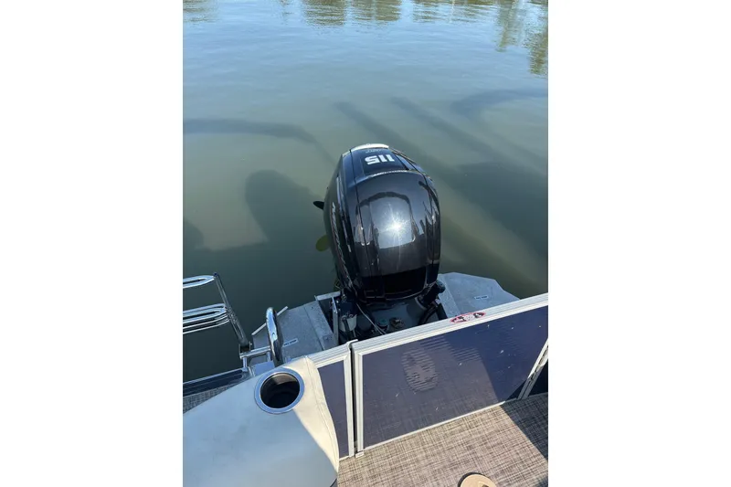 Slide: The Image of 2023 Cypress Cay Seabreeze 232 boat with outboard motor on calm water. - 9