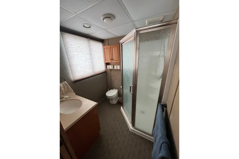 Slide: The Image of Bathroom interior of a 2009 Custom tritoon with shower, sink, and toilet. - 16