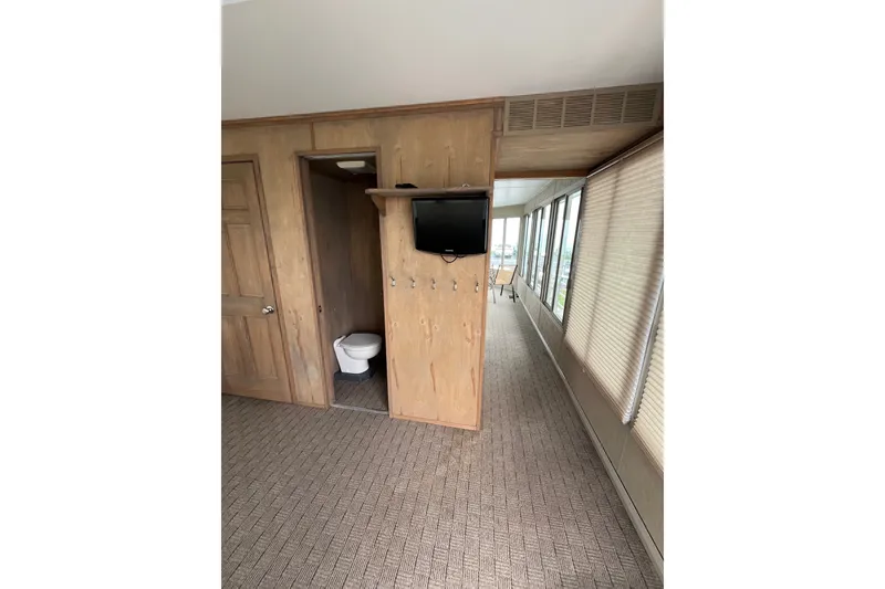 Slide: The Image of Interior of a 2009 custom tritoon with bathroom, TV, and large windows. - 31