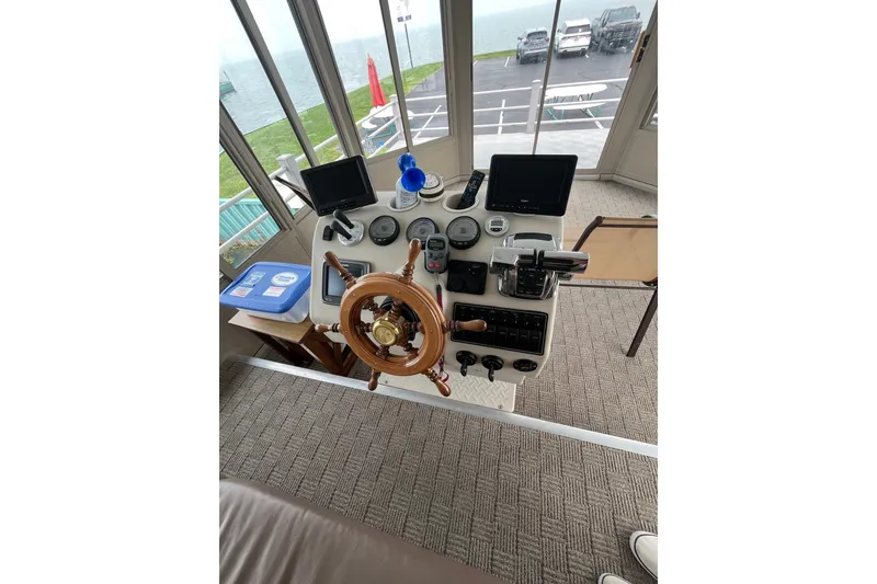 Slide: The Image of Steering console of a 2009 custom tritoon boat with gauges and controls. - 23
