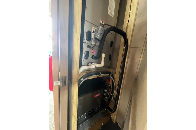 Slide: The Image of Interior view of a 2009 Custom tritoon showing mechanical components and wiring. - 34