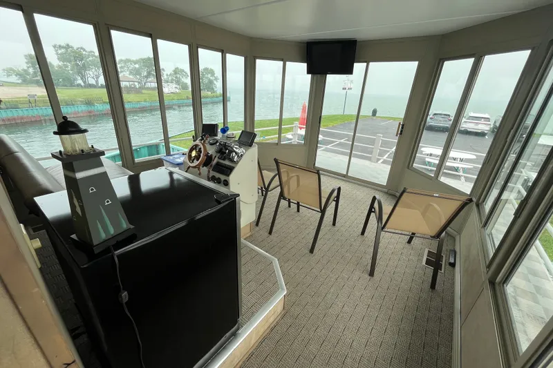 Slide: The Image of Interior of a 2009 custom tritoon with panoramic windows and modern helm. - 21