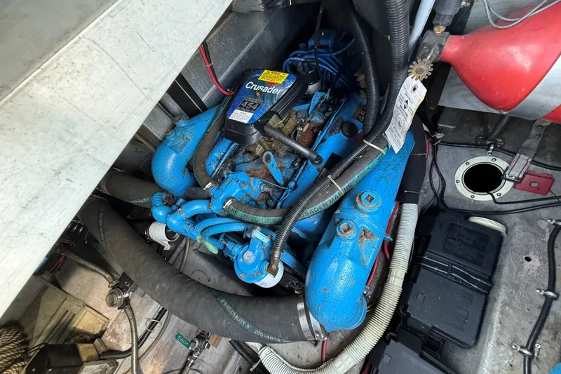 Slide: The Image of Engine compartment of a 1989 Carver 340 Santego boat, featuring a blue Crusader engine. - 29