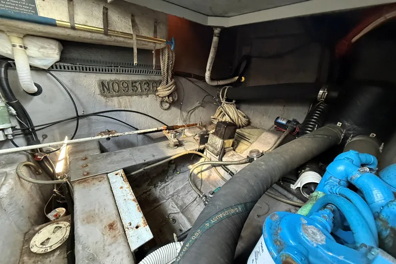 Slide: The Image of Engine compartment of a 1989 Carver 340 Santego boat, showing hoses and mechanical components. - 32