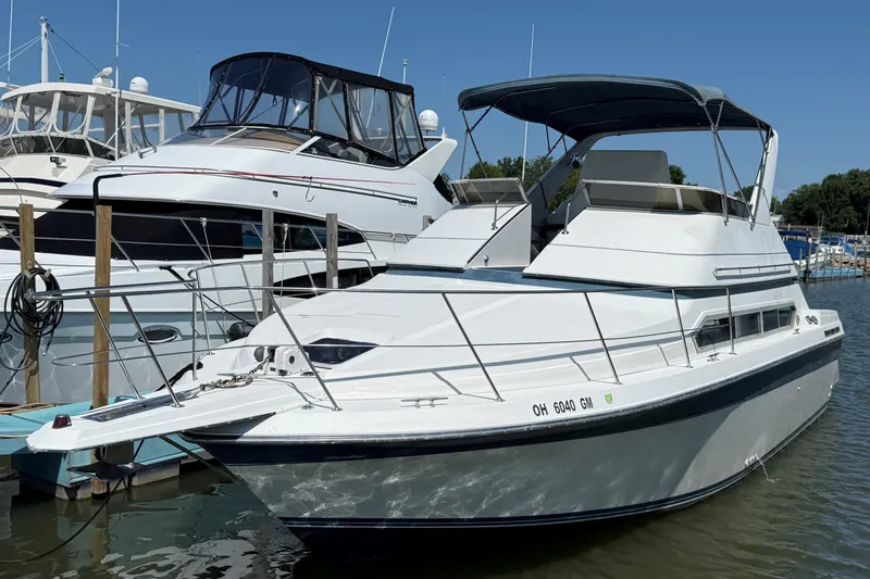 The Image of 1989 Carver 340 Santego yacht docked at marina under clear blue sky. - 0