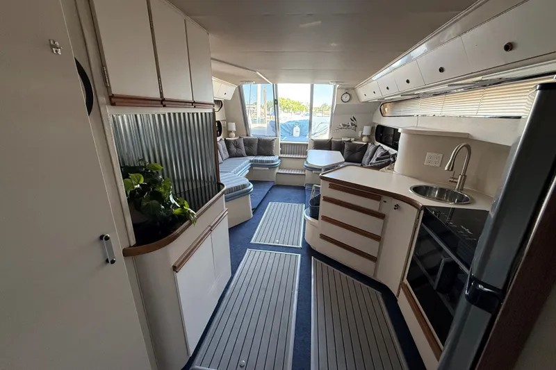 Slide: The Image of Interior of 1989 Carver 340 Santego yacht with modern kitchen and seating area. - 25