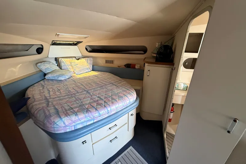 Slide: The Image of Cozy cabin interior of 1989 Carver 340 Santego with bed and storage. - 23