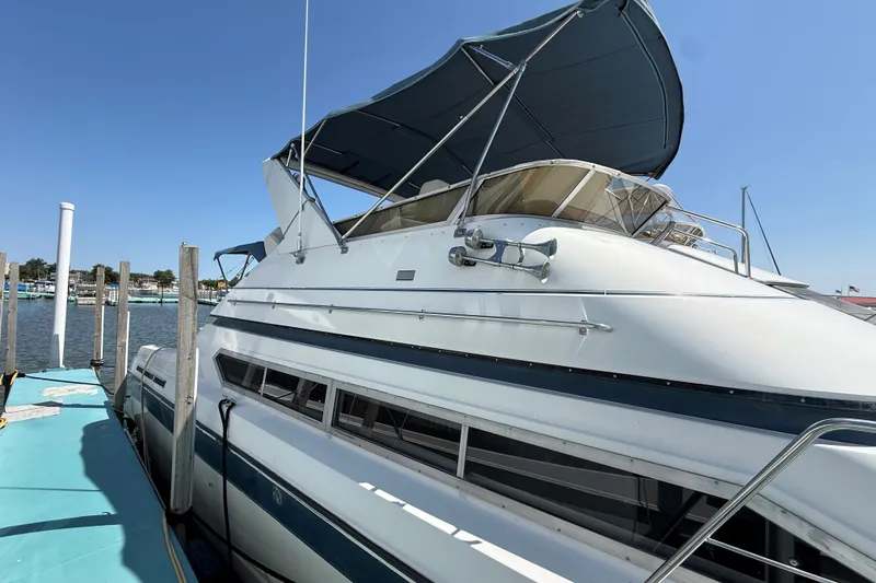 Slide: The Image of 1989 Carver 340 Santego yacht docked at marina under clear blue sky. - 3