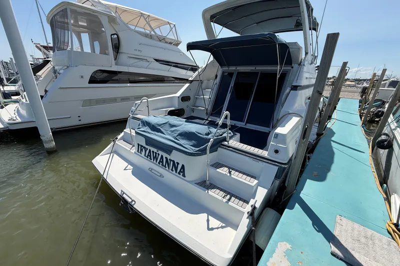 Slide: The Image of 1989 Carver 340 Santego yacht docked at marina, rear view with covered deck. - 4