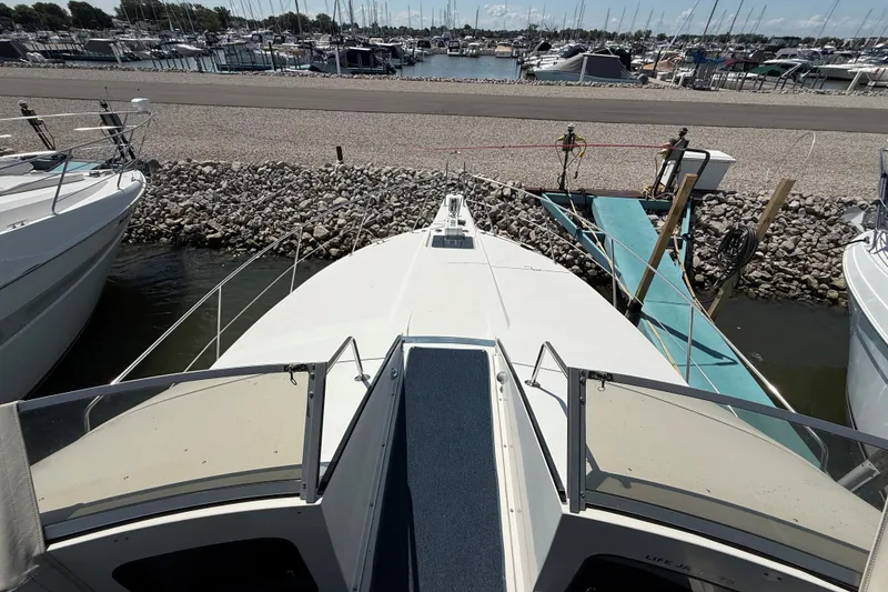 Slide: The Image of 1989 Carver 340 Santego yacht docked at marina, surrounded by other boats. - 13