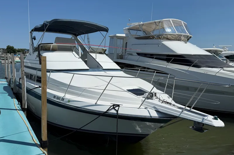 Slide: The Image of 1989 Carver 340 Santego yacht docked at marina under clear blue sky. - 2