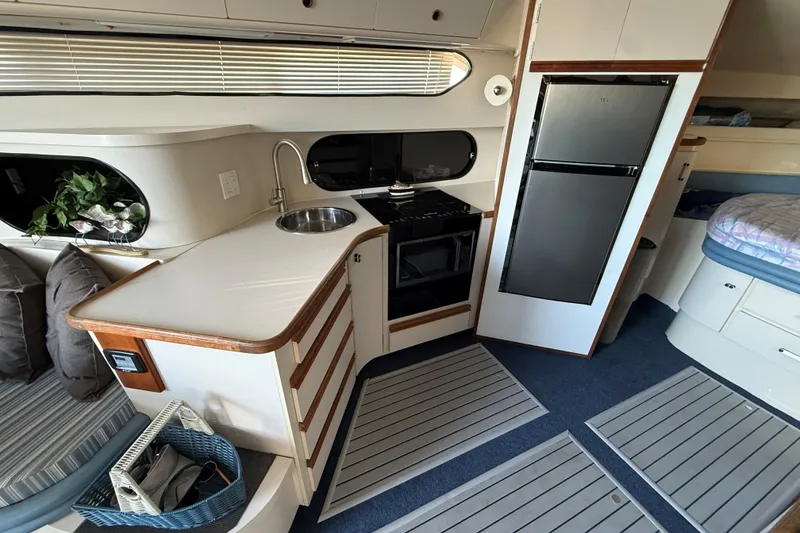 Slide: The Image of Interior of 1989 Carver 340 Santego yacht featuring kitchen area with sink and appliances. - 21