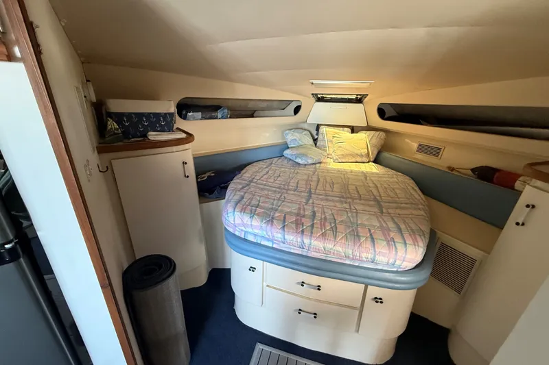 Slide: The Image of 1989 Carver 340 Santego cabin interior with cozy bed and storage cabinets. - 22