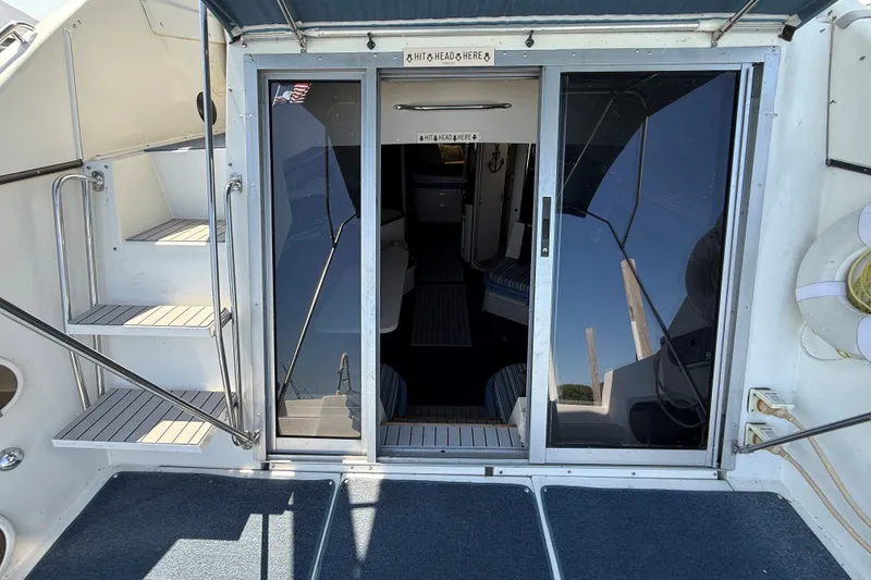 Slide: The Image of 1989 Carver 340 Santego yacht entrance with sliding glass doors and steps. - 18