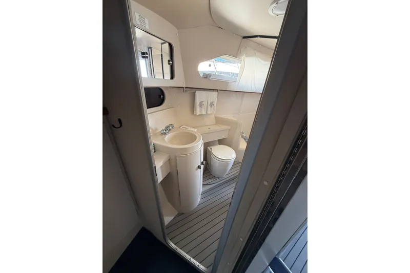 Slide: The Image of Bathroom interior of 1989 Carver 340 Santego yacht, featuring sink and toilet. - 24