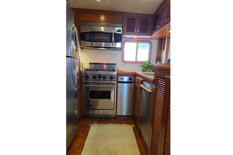 Slide: The Image of Galley with stainless steel appliances (Viking range) and granite countertops. - 7