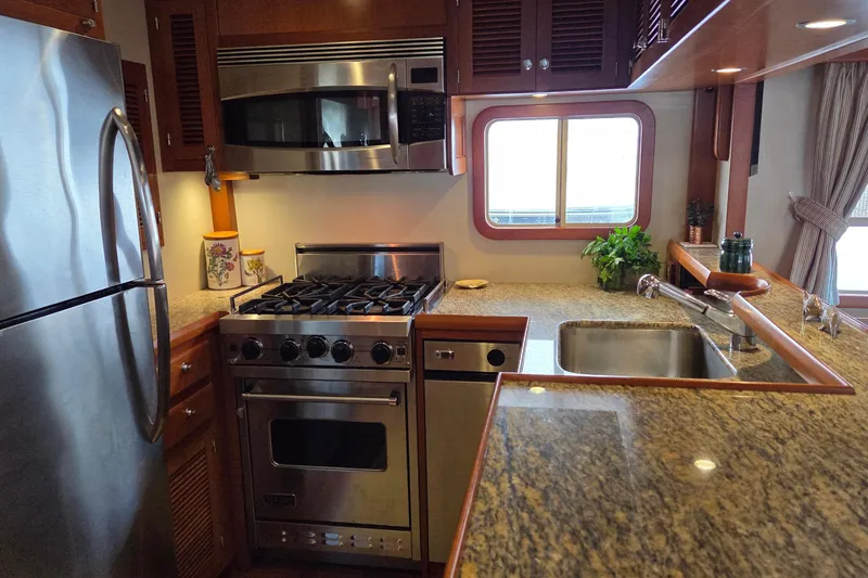 Slide: The Image of Galley with stainless steel appliances (Viking range) and granite countertops. - 6