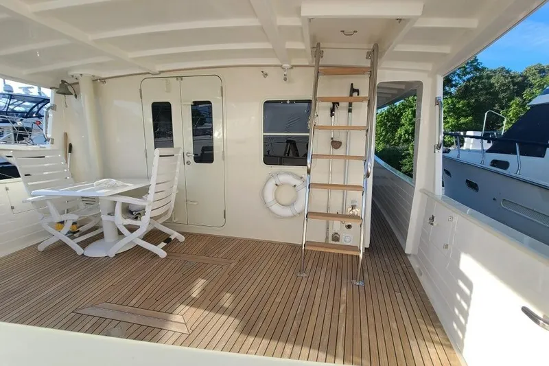 Slide: The Image of Spacious deck of 2010 Kadey-Krogen 48 North Sea yacht with seating and ladder. - 1
