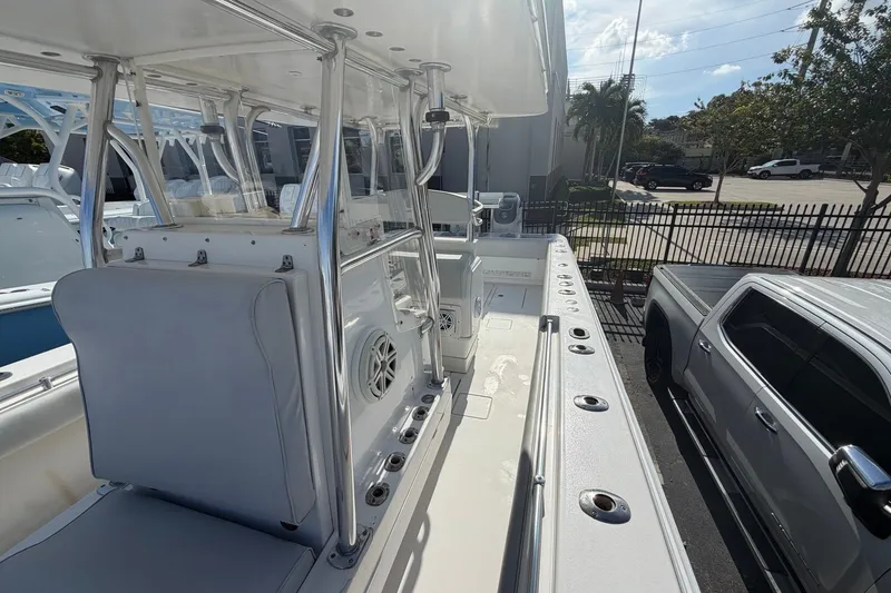 Slide: The Image of 2007 Contender 33 Tournament boat interior with seating and console, parked beside a truck. - 4