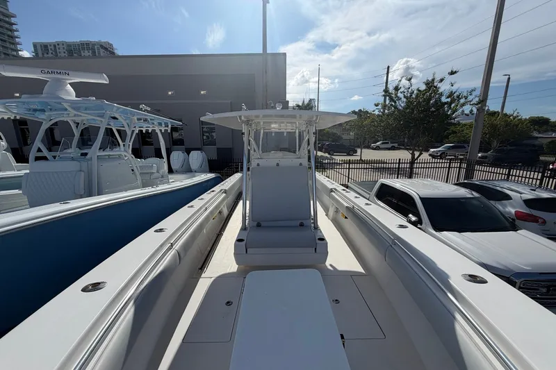 Slide: The Image of 2007 Contender 33 Tournament boat, docked outdoors, with clear skies and surrounding vehicles. - 11