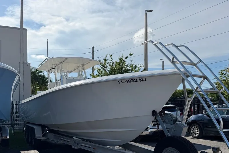 Slide: The Image of A white 2007 Contender 33 Tournament boat is on a trailer in a parking lot. - 1