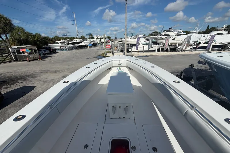 Slide: The Image of 2007 Contender 33 Tournament boat in marina, surrounded by other vessels under a clear sky. - 10