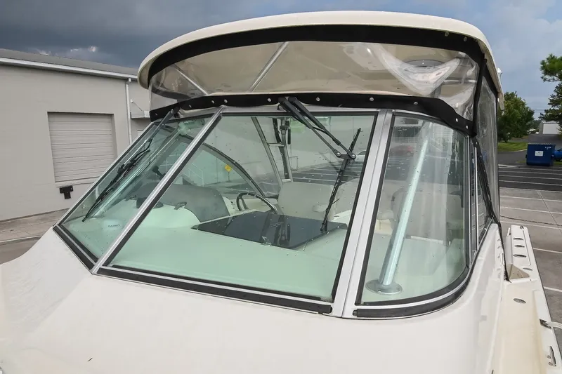 Slide: The Image of 2007 Pursuit OS 285 Offshore boat with windshield and wipers, docked outdoors. - 42