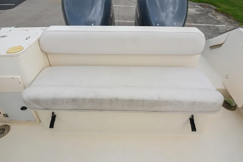 Slide: The Image of 2007 Pursuit OS 285 Offshore boat seat with dual engines in background. - 13