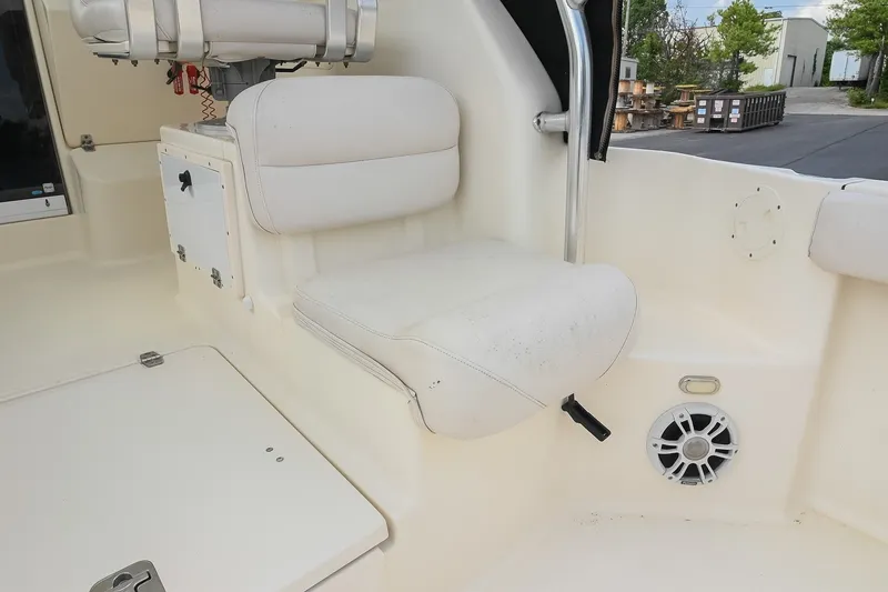 Slide: The Image of 2007 Pursuit OS 285 Offshore boat interior with white seating and speaker. - 19