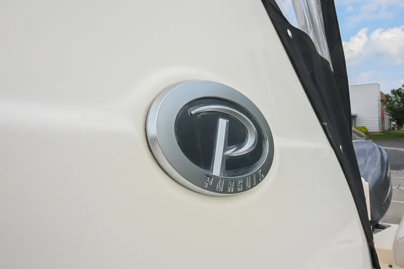 Slide: The Image of 2007 Pursuit OS 285 Offshore boat emblem close-up with logo detail. - 8