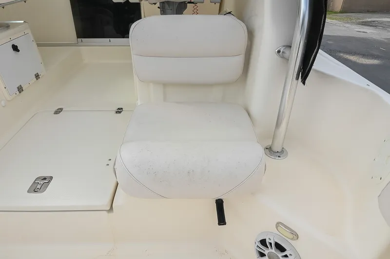 Slide: The Image of 2007 Pursuit OS 285 Offshore boat interior with white seating and storage compartments. - 20