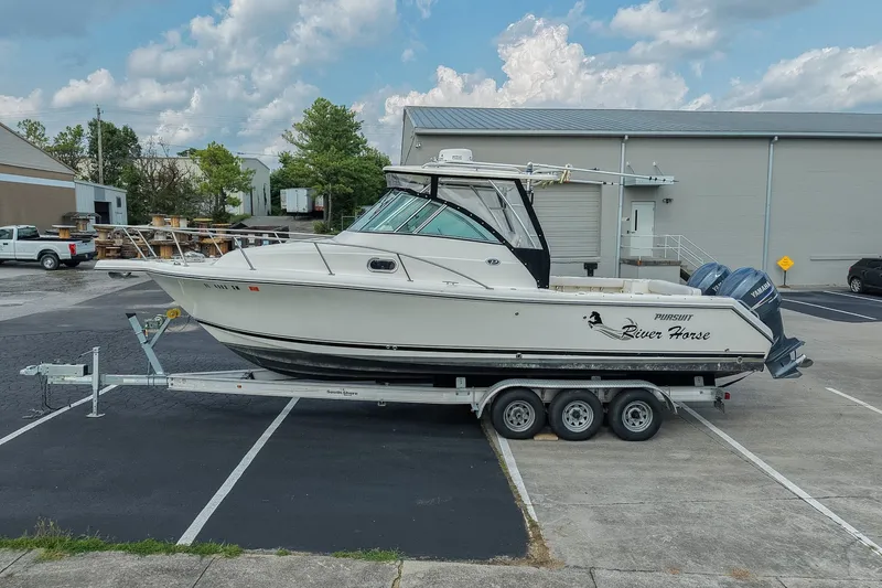 Slide: The Image of 2007 Pursuit OS 285 Offshore boat on trailer in parking lot, side view. - 1