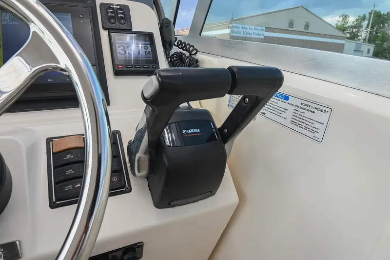 Slide: The Image of 2007 Pursuit OS 285 Offshore boat dashboard with Yamaha controls and steering wheel. - 28