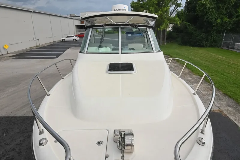 Slide: The Image of 2007 Pursuit OS 285 Offshore boat with Garmin equipment, docked near a parking lot. - 39