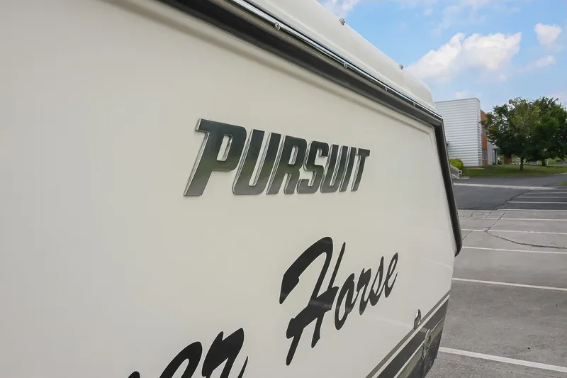 Slide: The Image of 2007 Pursuit OS 285 Offshore boat in a parking lot, showcasing brand logo. - 9