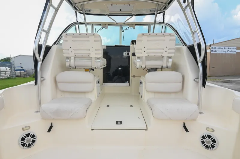 Slide: The Image of 2007 Pursuit OS 285 Offshore boat interior with seating and helm station. - 16