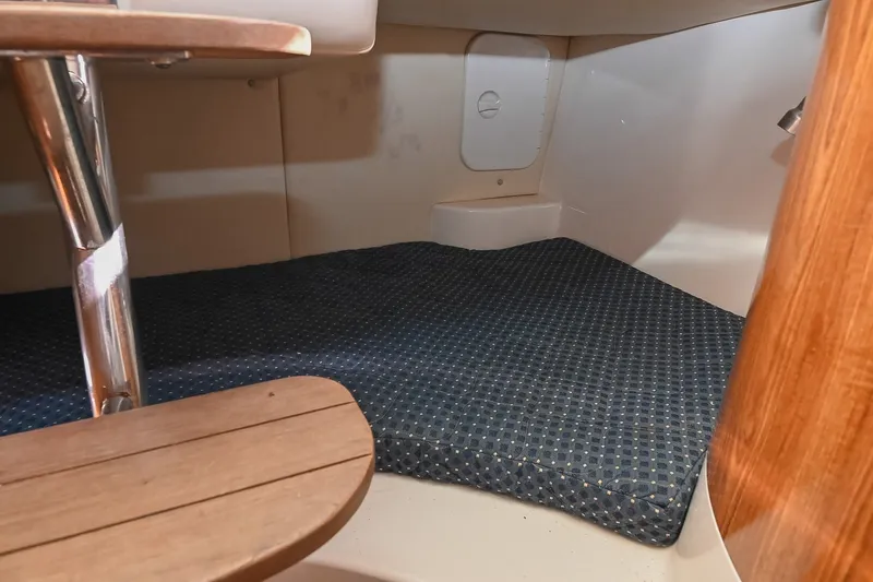 Slide: The Image of 2007 Pursuit OS 285 Offshore cabin interior with wooden steps and cushioned sleeping area. - 35