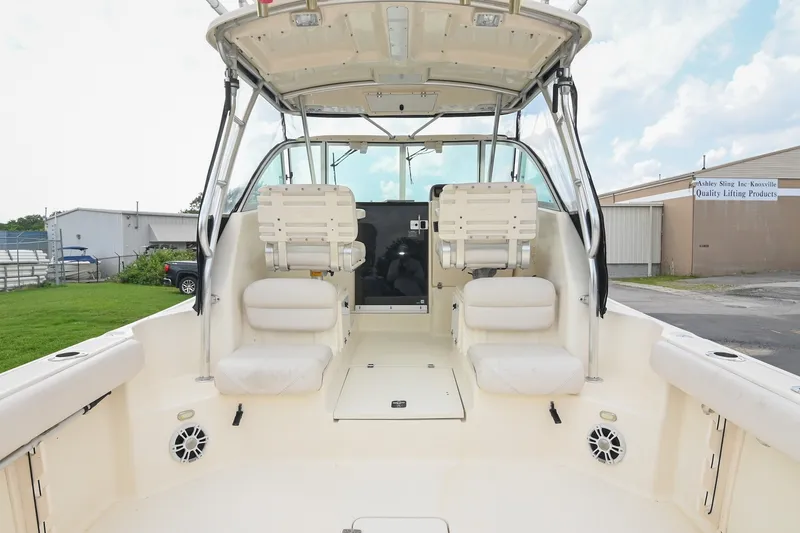 Slide: The Image of 2007 Pursuit OS 285 Offshore boat interior with seating and helm, showcasing spacious design. - 10