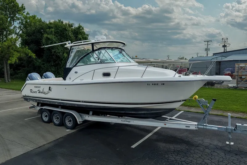 The Image of 2007 Pursuit OS 285 Offshore boat on trailer, parked outdoors under cloudy sky. - 0