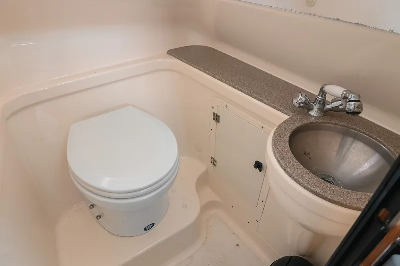 Slide: The Image of 2007 Pursuit OS 285 Offshore boat bathroom with toilet and sink. - 34