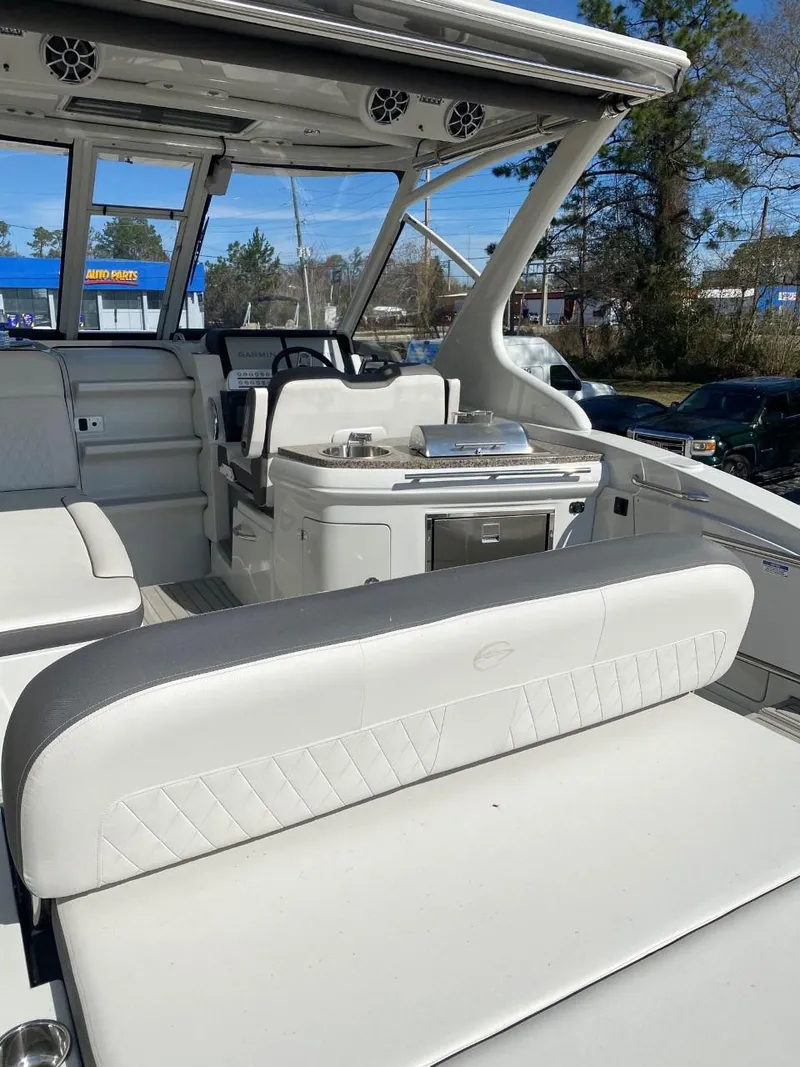 Slide: The Image of The image shows the cockpit of a 2023 Crownline 310 CRX with white upholstery and helm station. - 7