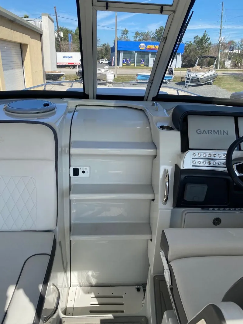 Slide: The Image of The image shows the cockpit of a 2023 Crownline 310 CRX with a Garmin navigation system. - 11