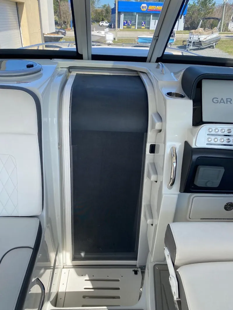 Slide: The Image of The image shows the cockpit of a 2023 Crownline 310 CRX with modern controls and seating. - 12